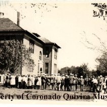 people in front of a tall buiding